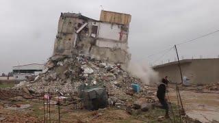 Damaged building in Aleppo topples in aftershock