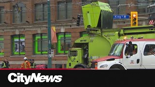 A garbage truck downs TTC streetcar wires closing the intersection at King and Spadina