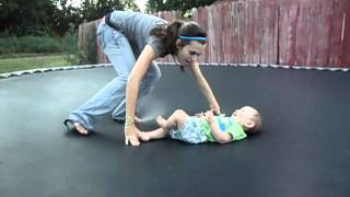 Cute baby laughing and bouncing on trampoline.AVI