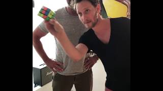 Gerard Butler solving a rubics cube behind his back... (with a little mental help from Lior Suchard)