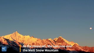 Sun and moon appear over Meili Snow Mountain