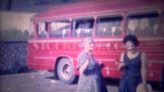 1963: Italian woman grandma wait red tour bus travel sightseeing. ROME, ITALY