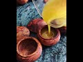 Natural Wisdom Blackseed & Lemon Balm Lip Saviour being poured into its wooden pot.