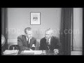 stock footage 1950 s two businessmen look over a document rise and shake hands.