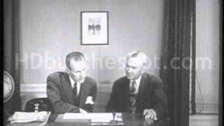 Stock Footage - 1950's TWO BUSINESSMEN LOOK OVER A DOCUMENT, RISE AND SHAKE HANDS.