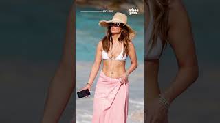 Jennifer Lopez in white bikini with her iPhone