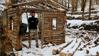 Bushcraft winter house in the woods . Survival shelter.log cabin