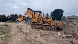 Levelling out a clean fill site with the International 100 crawler loader ￼