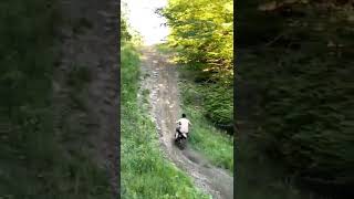 Crazy shirtless dirt bike rider doing some hills