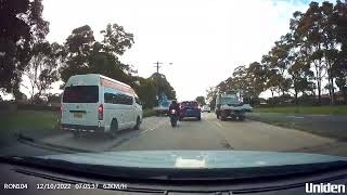 Motorcyclist riding recklessly between cars