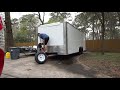 installing logo graphics on the race car trailer.