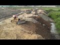 up new soil and dump trucks fill the soil bulldozer kumatsu pushing dirt