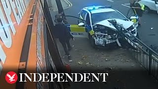 Police car slams into railing after colliding with another vehicle