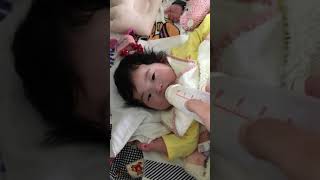 ミルクを飲みながら笑う赤ちゃん　Baby laughing while drinking milk