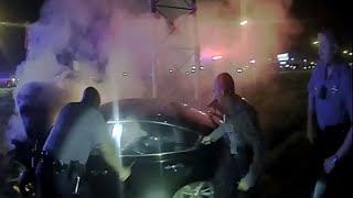 Police bodycam video shows rescue from burning car
