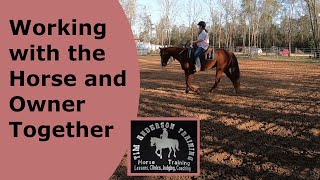 Owner taking a lesson on her horse in training