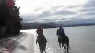 Ian riding Jess at Tuapiro Beach