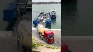 Two cement tankers are getting off the ferry and crossing the river. Ferry crossing the river. L