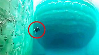 Underwater Camera Captures Massive Shape Passing Below Divers