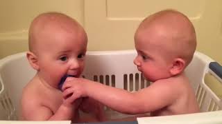 Twin pacifier fight in bath