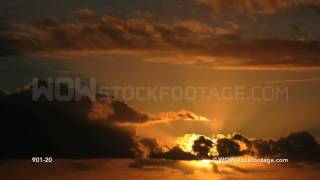 Time-lapse of sun shining through cloud at sunrise
