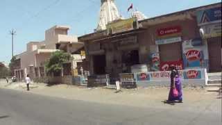 Riding a scooter around Sisodra village, Navsari, Gujarat, India; 25th May 2012