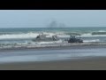 Boat launch in  big shorebreak waves New Zealand 90 mile beach