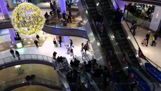 Slightly defocused crowd of people on escalator in the newly opened shopping mall center