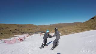 Couple snowboarding at afriski