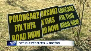 Using signs to fix potholes in town of boston