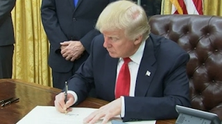 Raw: Trump Signs 1st Executive Order As President