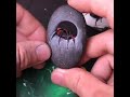 carving a stone into a black widow spider