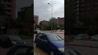 ITALY: Slow moving traffic crawls along waterlogged road in Milan