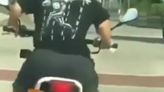 Midget rides a motorbike