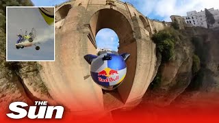 Daredevil wingsuit pilot flies under Puento Nuevo arch in Ronda, Spain