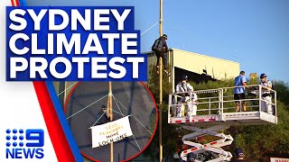 Climate change protester suspends himself on pole above major Sydney highway | 9 News Australia
