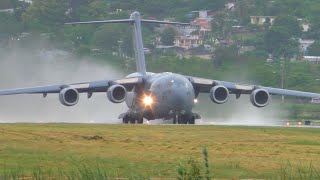 Air Force McChord C-17 Taking off from Ponce on an afternoon with a very wet runway .