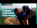 Turkish policeman helps injured Syrian woman