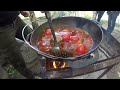 cooking an amazing goulash outdoors. the cauldron was almost bursting with flavor.