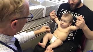 Doctor distracts baby from shots