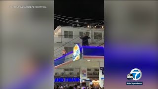 Bad Bunny throws impromptu concert on top of gas station in Puerto Rico