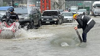 Clearing a Flooded Road Unclogging a Blocked Grate After the Storm