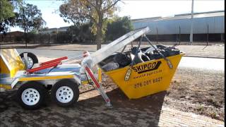 Superior loading of a mini skip by a Skipgo agent. Manufactured by SkipRent.(www.skiprent.co.za)