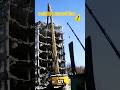 majestic big excavator bringing down building demolition site