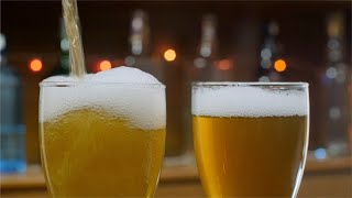 Bokeh shot of pouring fresh beer and a foam into the glass | Indian Stock Footage | Knot9