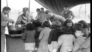 US soldiers feeding Italian children in a mess tent in Vairano, Italy. HD Stock Footage