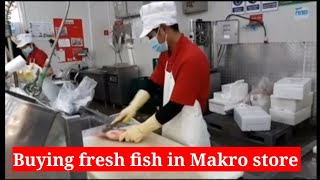 Buying fresh fish in Makro store Pattaya