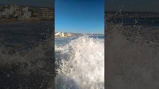 THE COLLISION OF WAVES WITH BLACK MARINE ROCKS''IT THE SPLENDOR THE RELAXING OF TAGHAZOUT BEACH.
