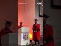 daughter cheers on dad during graduation