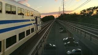 LIRR Doubledecker train going through amazing sunset sky through Bellmore New York